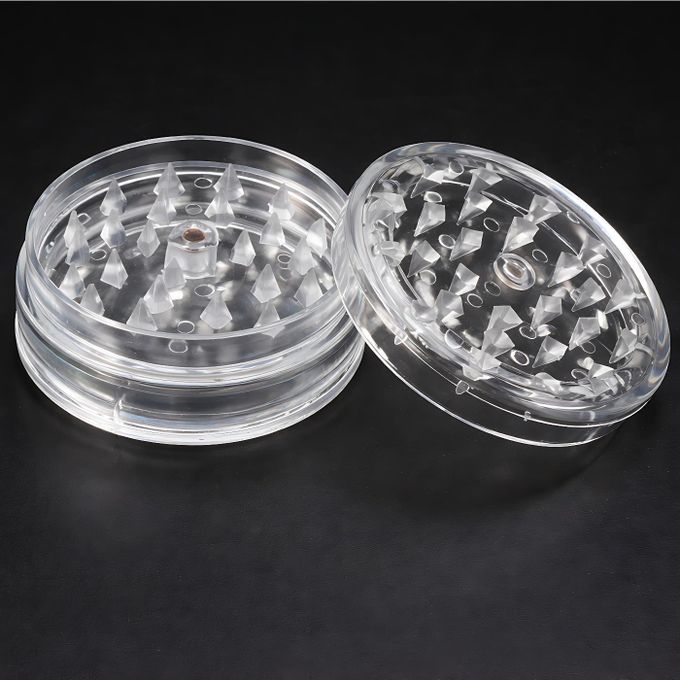 Lightweight, transparent plastic herb grinder with sharp teeth for tobacco, herbs, and spices
