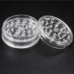 Lightweight, transparent plastic herb grinder with sharp teeth for tobacco, herbs, and spices